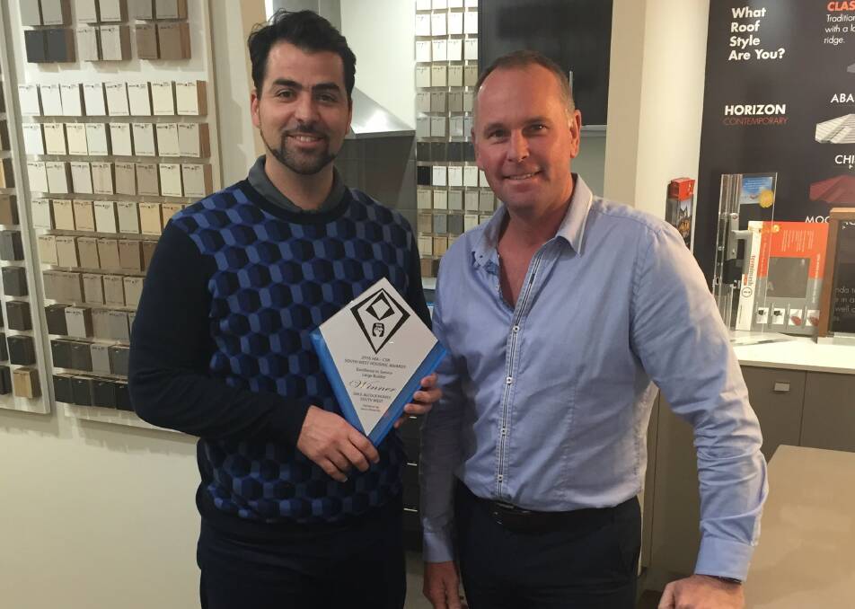 General Manager, Steve Hancock and Sales Manager, Ben Beven with the award for service excellence.