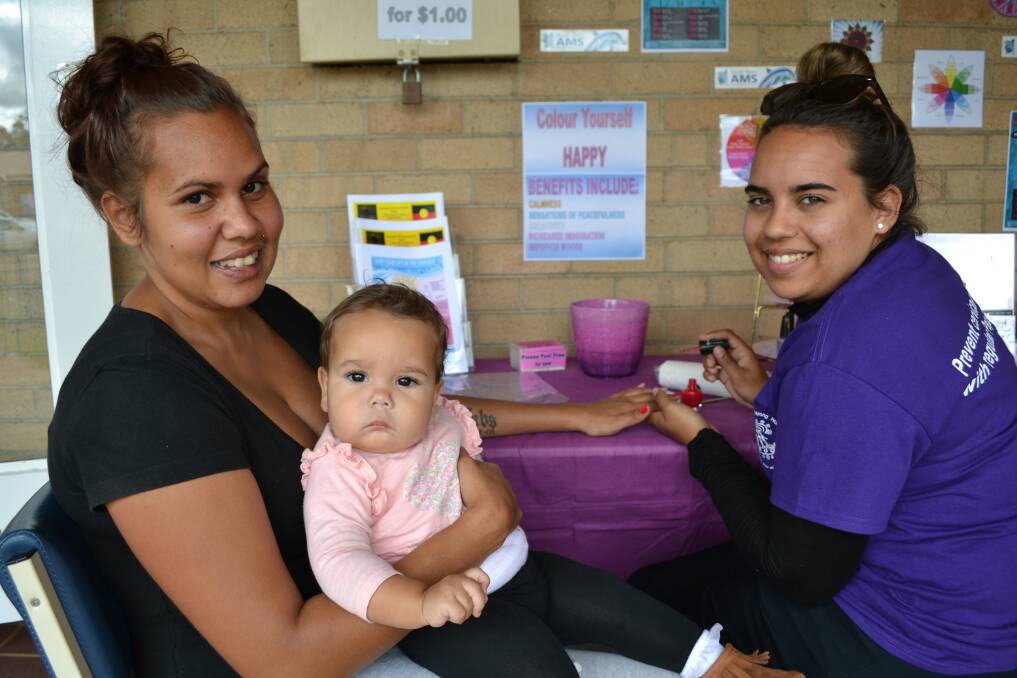 South West Aboriginal Medical Service employee Talicia Jetta (right) pampers Kaeann Hill, with her daughter Mya.