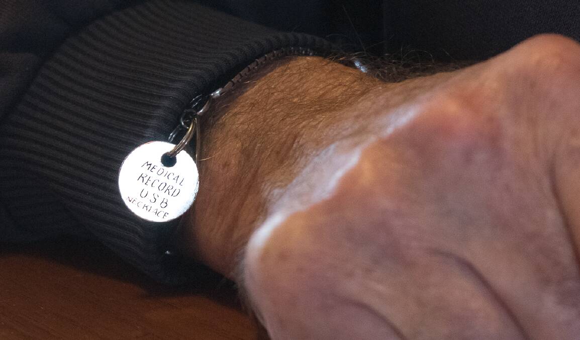 Philip Wright had a tag added to his medic alert bracelet which lets doctors and emergency service staff know he keeps a copy of his medical records on a USB drive on a chain around his neck. Photo: Jem Hedley.