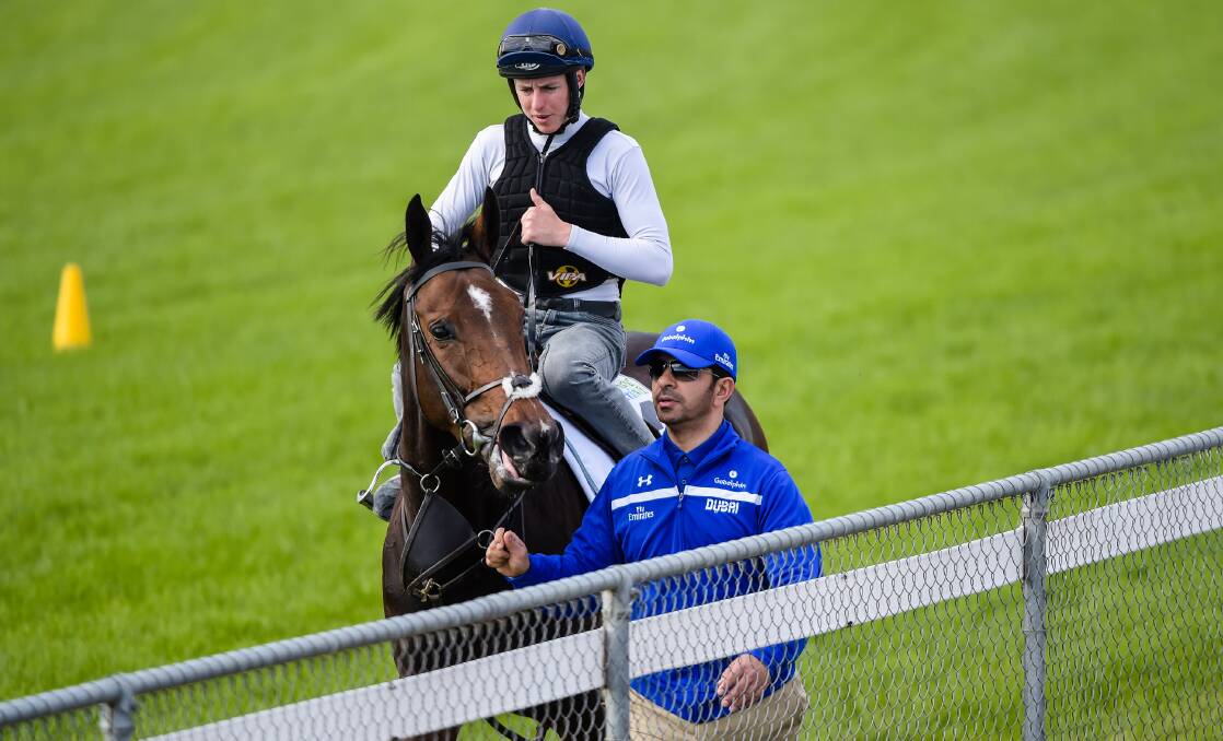 Bunbury born jockey Damian Lane aboard Beautiful Romance at Werribee for track work alongside trainer Saeed Bin Suroor. The group hope to claim victory in Tuesday's Melbourne Cup. Photo: Getty Images.