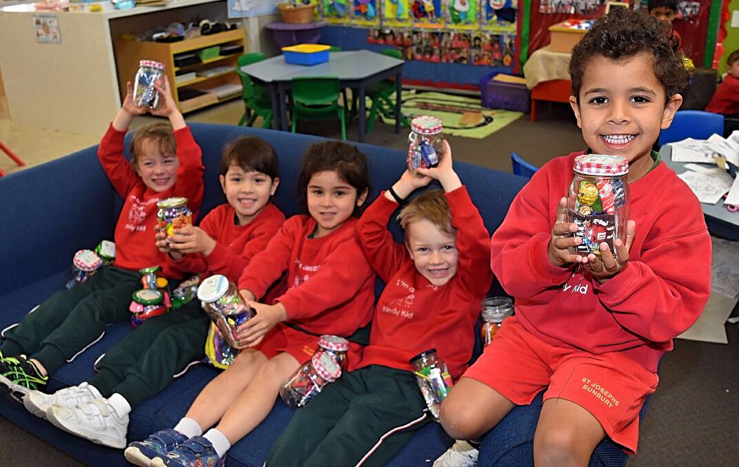 St Joseph's Catholic Primary School kindy students Dylan, Crystal, Sophia, Creasey and Lucas show off some of the lolly jars that will be up for sale at the upcoming family fun day. Photo: Andrew Elstermann. 