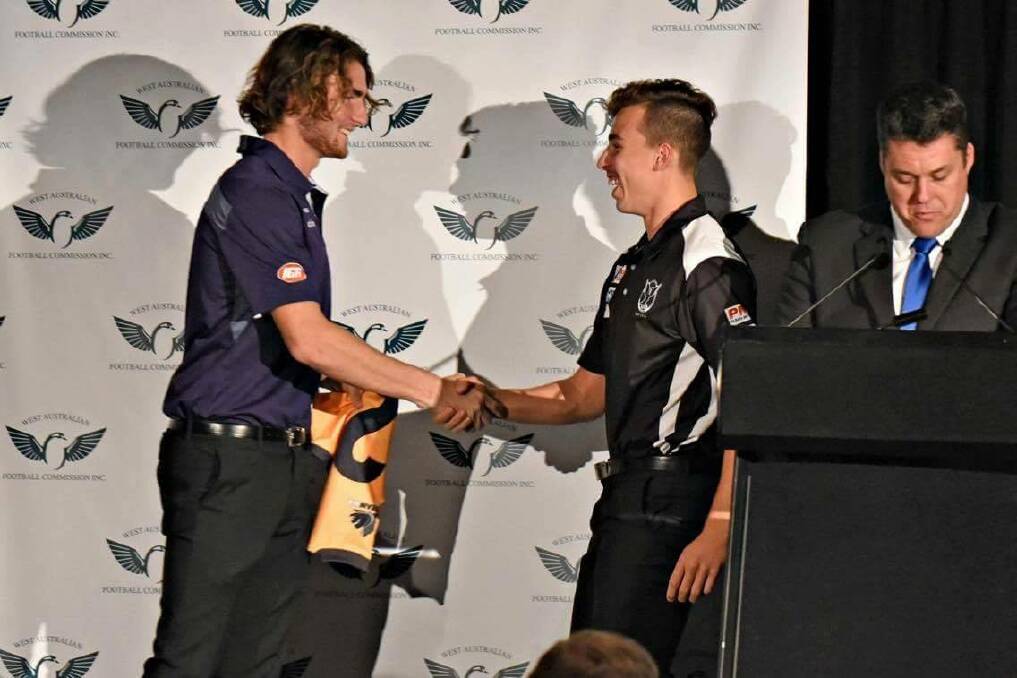 Fremantle Docker Connor Blakely presenting Aidan Clarke with his WA state 18s jumper. 
