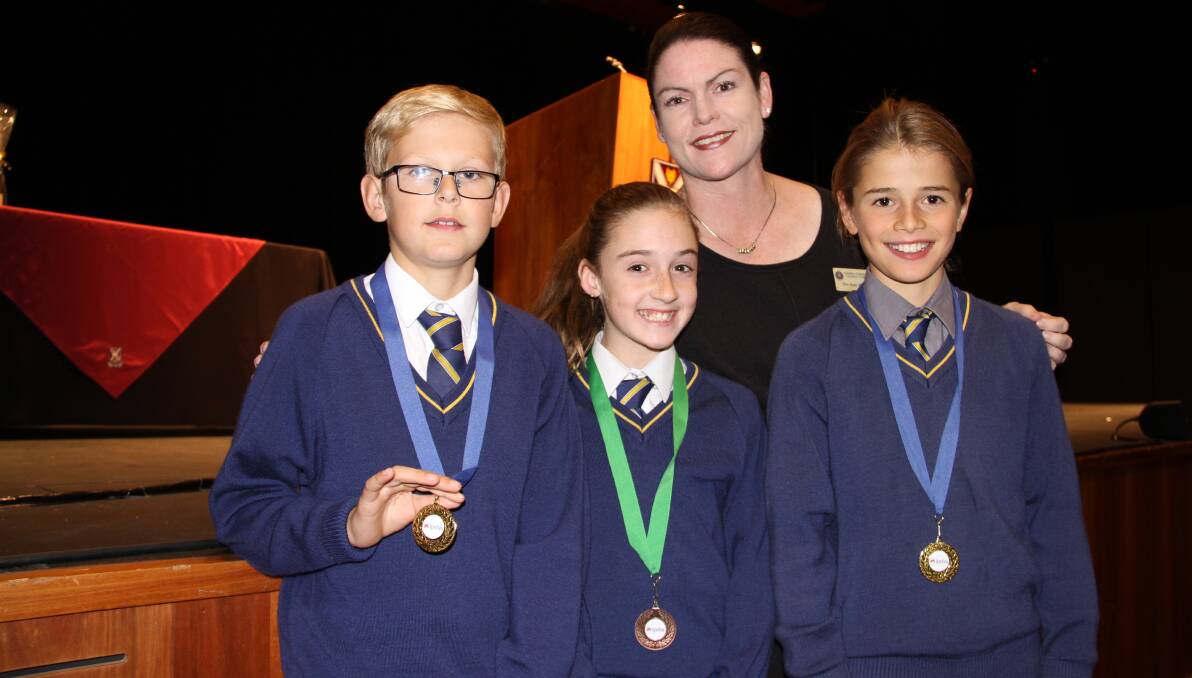 Bunbury Cathedral Grammar School teacher Kate Holdman with students William Darlow, Ella McCarthy and Jake Townsend-Hyde at the competition in Perth. 