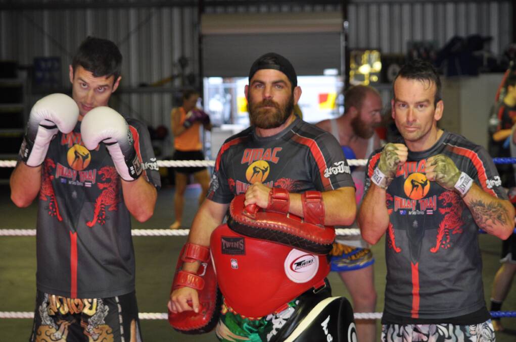 Winning attitudes: Fighter Chris Morten, trainer Jason Lea, and fighter Ross Oldham in the rings at Odine's   Martial Arts Centre. Photo: Thomas Munday. 