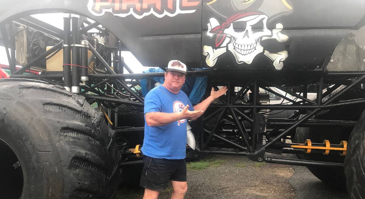 THEFT: Troy Garcia with the Monster Truck, minus its motor, in for repairs at a Rutherford factory. The $15,000 motor was stolen from the vehicle which was on display  on the the highway at Hexham. Photo: Supplied.