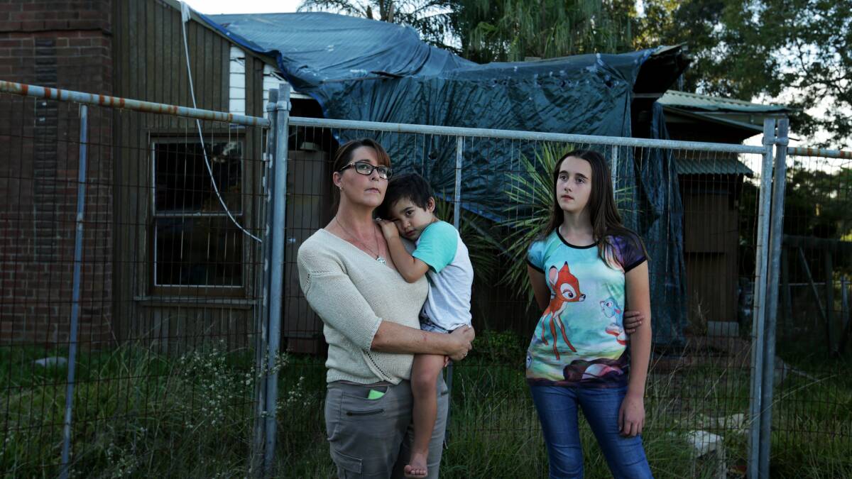 HOMELESS: Kellie Hancock with her children Trinitie, 12, and Charlie, 4, at their storm-damaged Teralba home AAMI has refused to replace. Picture: Simone De Peak