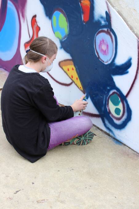 One of the youth, Layla Rafferty, involved in the award winning project, painting the new design on the Capel skate park as part of Captivate Capel.