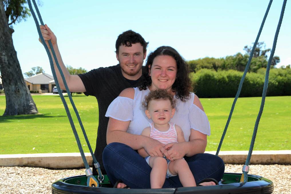 FIFO families: Kody and Jodie Montgomery with their 15 month old daughter Hannah, believe shorter swings would help improve the mental health of workers. Photo: Emily Sharp.
