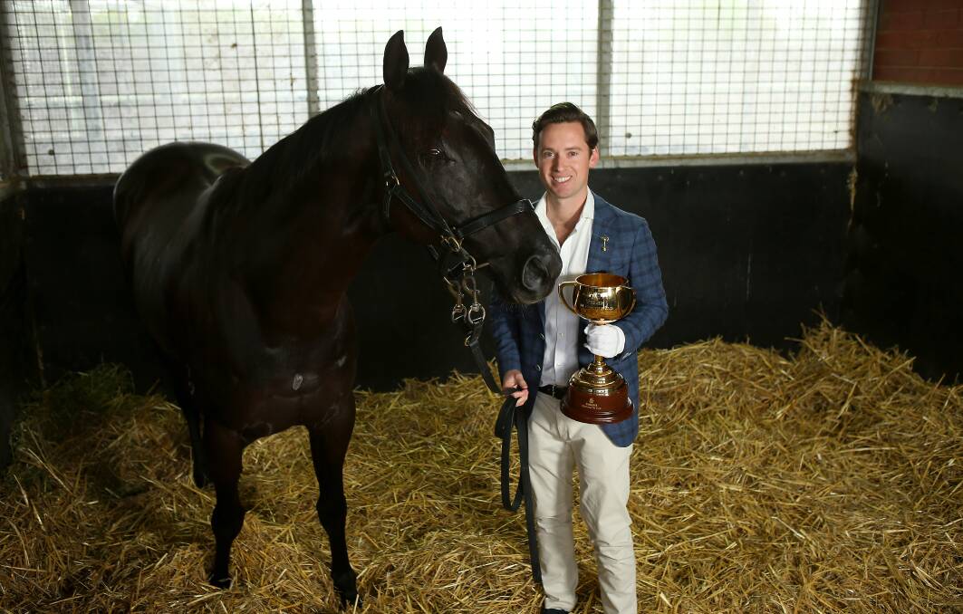Trainer Adrian Bott with The Melbourne Cup and his Melbourne Cup entrant Excess Knowledge. Photo: Getty Images.