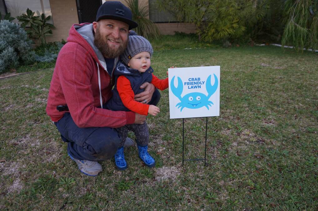 Luke and Dylan Conwell with their crab-friendly lawn in Broadwater. Bunbury Bunnings vouchers are up for grabs for locals that participate in the 'Save The Crabs, Then Eat Them' campaign.