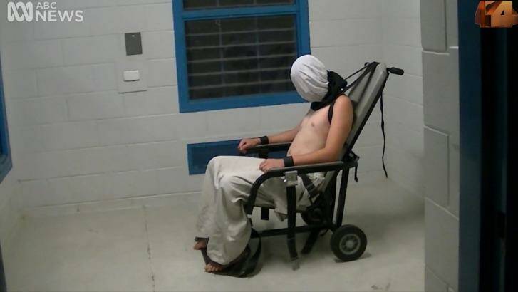 Dylan Voller is hooded and strapped to a restraining chair in the footage aired on Four Corners. Photo: ABC Four Corners
