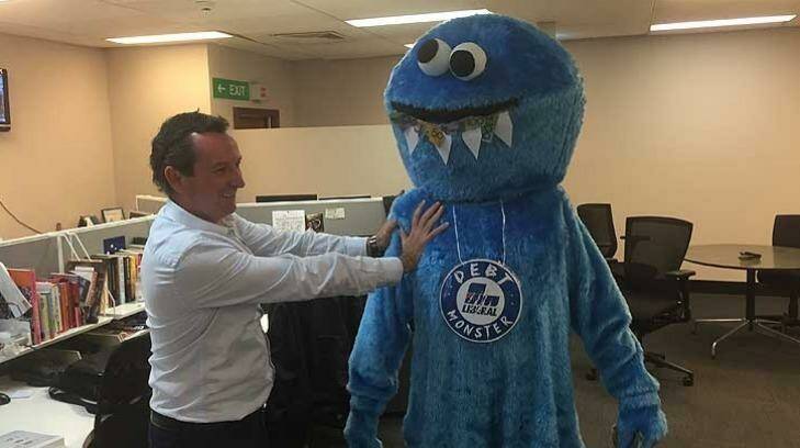 MarK McGowan and "the debt monster" make an impromptu visit to the Fairfax Media offices