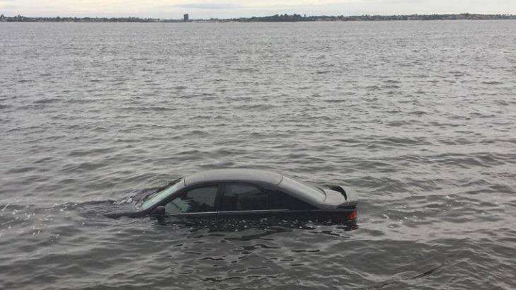 The car in the Swan River after the incident. Photo: Nicolas Perpitch / ABC Perth