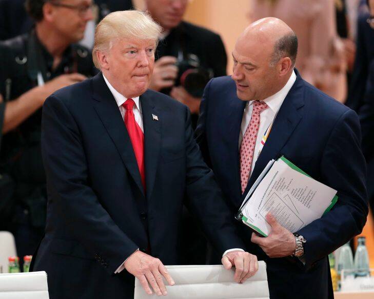 White House chief economic adviser Gary Cohn, right, talks to U.S. President Donald Trump, left, prior to a working session at the G-20 summit in Hamburg, northern Germany, Saturday, July 8, 2017. The leaders of the group of 20 meet July 7 and 8. (AP Photo/Michael Sohn)