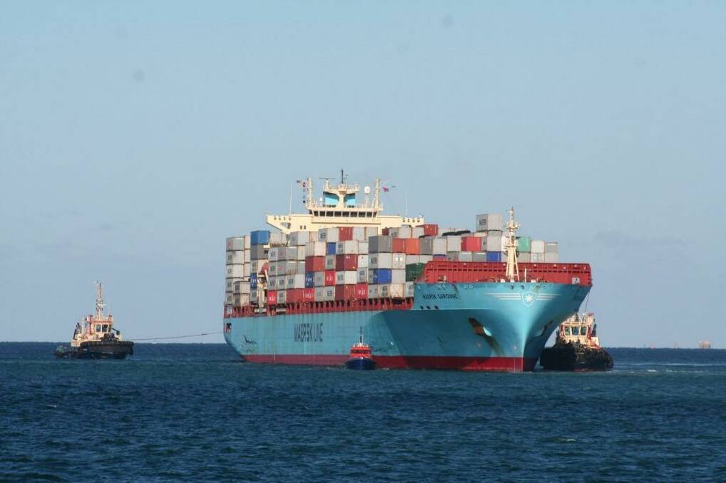 Tugs try to free the container ship Maersk Garonne after it ran aground in Fremantle Harbour. Photo: Brendan Foster