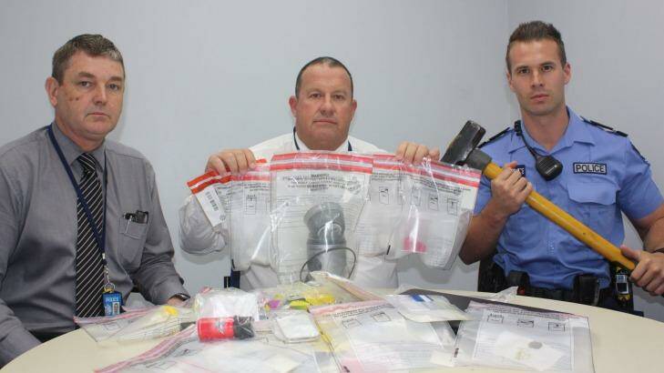 Detectives with some of the material allegedly seized.   Photo: Emma Young 
