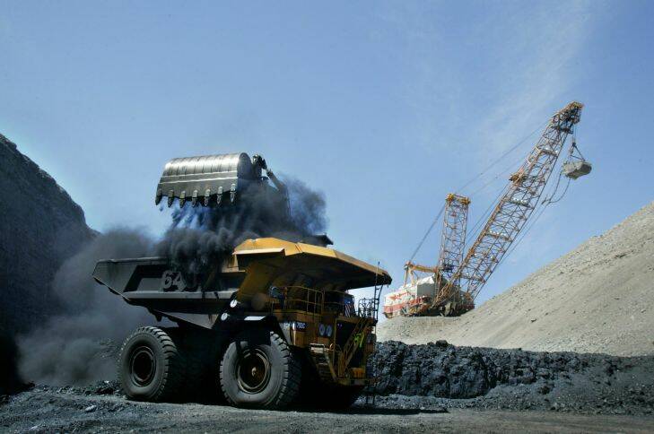 open cut coal mine. a drag line removes over burden to get at the coal seam as a mechanical shovel loads the coal into a truck at the peak downs open cut coal mine. owned by bhp billiton mitsubishi alliance, near moranbah, queensland. mon 21 mar 05 afr pix robert rough. generic. coal, open cut, mines, mining, coal truck, big truck, drag line, fuel, fossil fuel, exports, environment. SPECIALX 34916