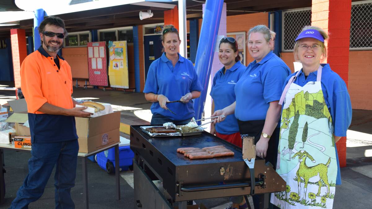 James Pinfold getting a bun and snag from Adam Road Primary School P&C girls Katrina Buswell, Andrea Chatfield, Laura Sciesinskin and Robyn Wilson. 