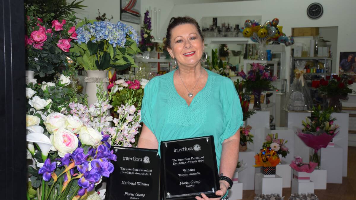 Bunbury’s Florist Gump owner Jenny Scott proudly showing off both the state and national awards after the business claimed victory at the Interflora Pursuit of Excellence awards night in Melbourne.