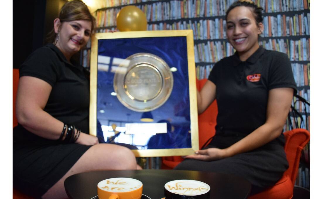 Caf-Fez has been crowned the Gold Plate Award’s WA coffee shop of the year. Pictured are manager Savina Scibilia and assistant manager Jasmine Karati with the plate and accompanying cappuccino art.