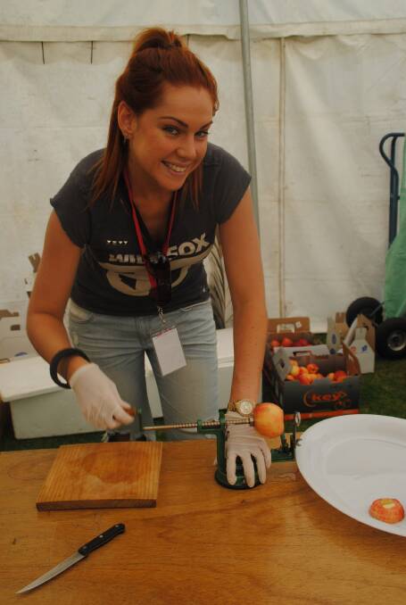 Caitlin Downton prepares apples to taste in the produce tent.
