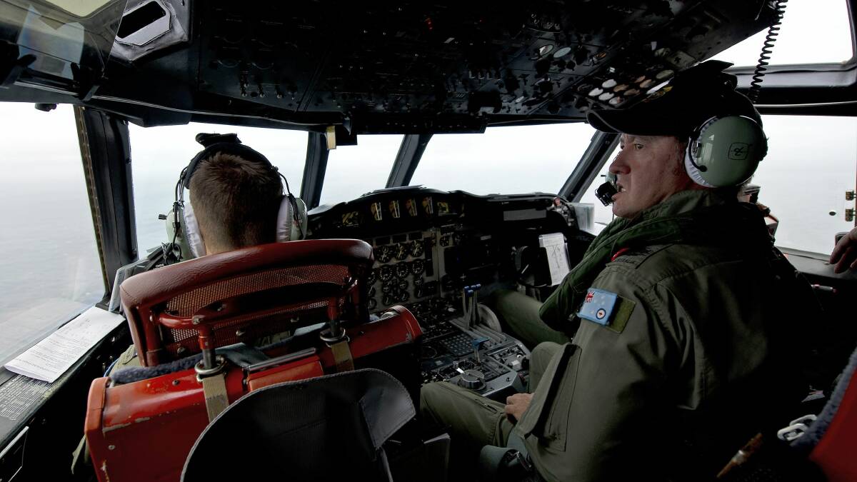 Royal Australian Air Force Flight Engineer, Warrant Officer Ron Day from 10 Squadron, keeps watch for any debris as he flies in an AP-3C Orion over the Southern Indian Ocean during the search for missing Malaysian Airlines flight MH370, in this picture released by the Australian Defence Force on March 20, 2014. 