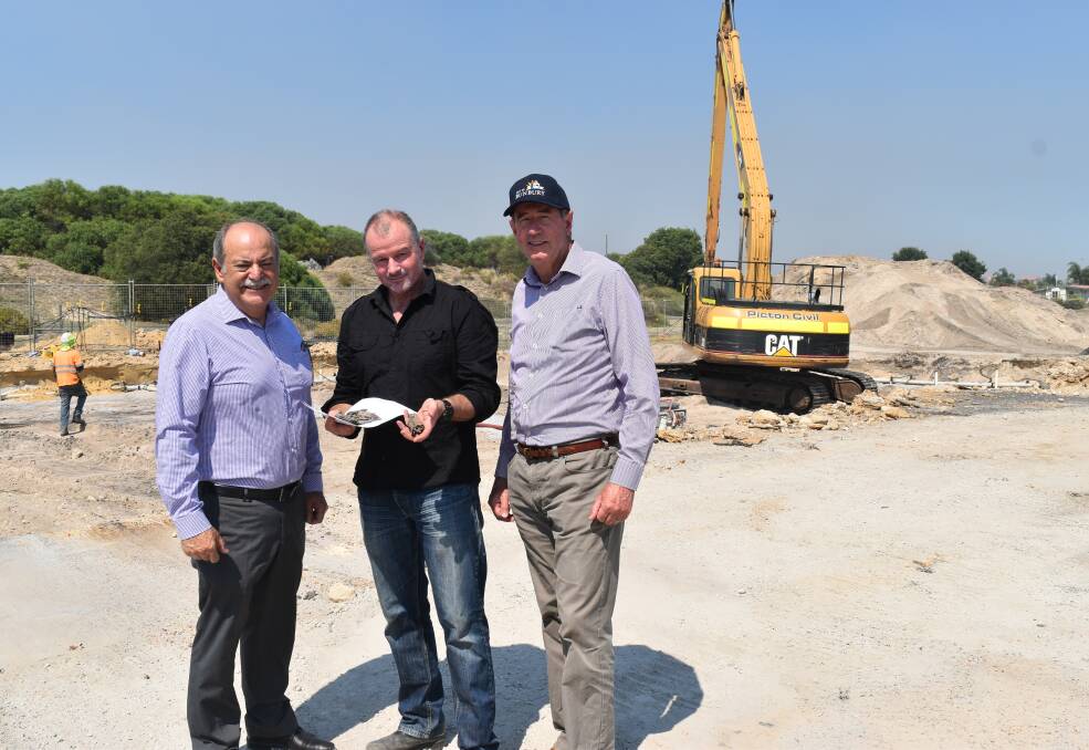 Bunbury MLA John Castrilli, West Australian Museum Department of Maritime Archaeologist Ross Anderson holding the timber which floated to the surface and Mayor Gary Brennan standing on the site where the ship may be buried. 