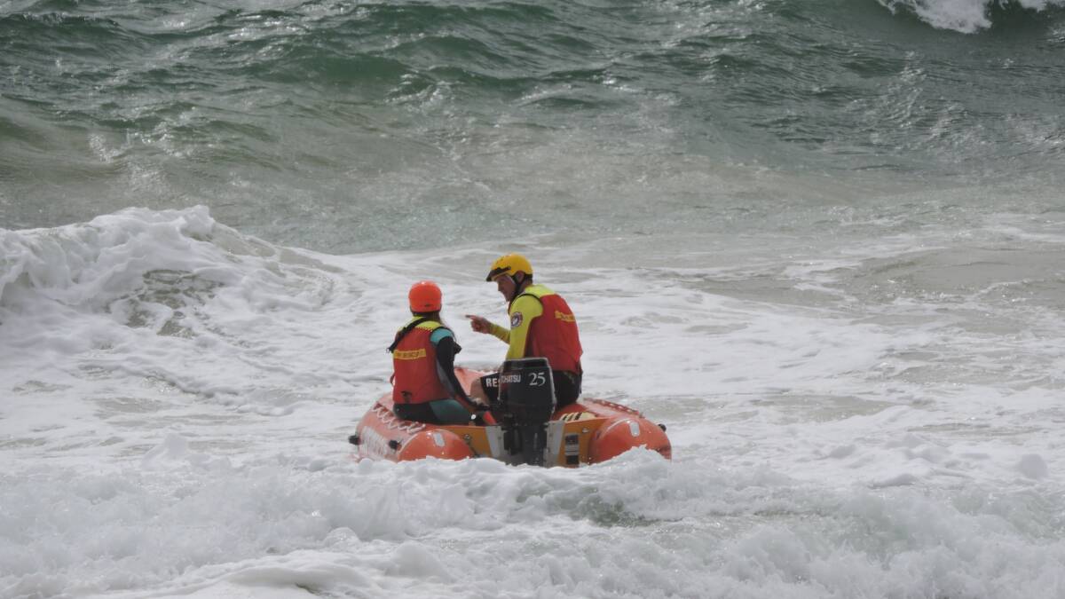 Patrol captain Jim Smith (right) showing Shannon Hill how to overcome rough waves.
