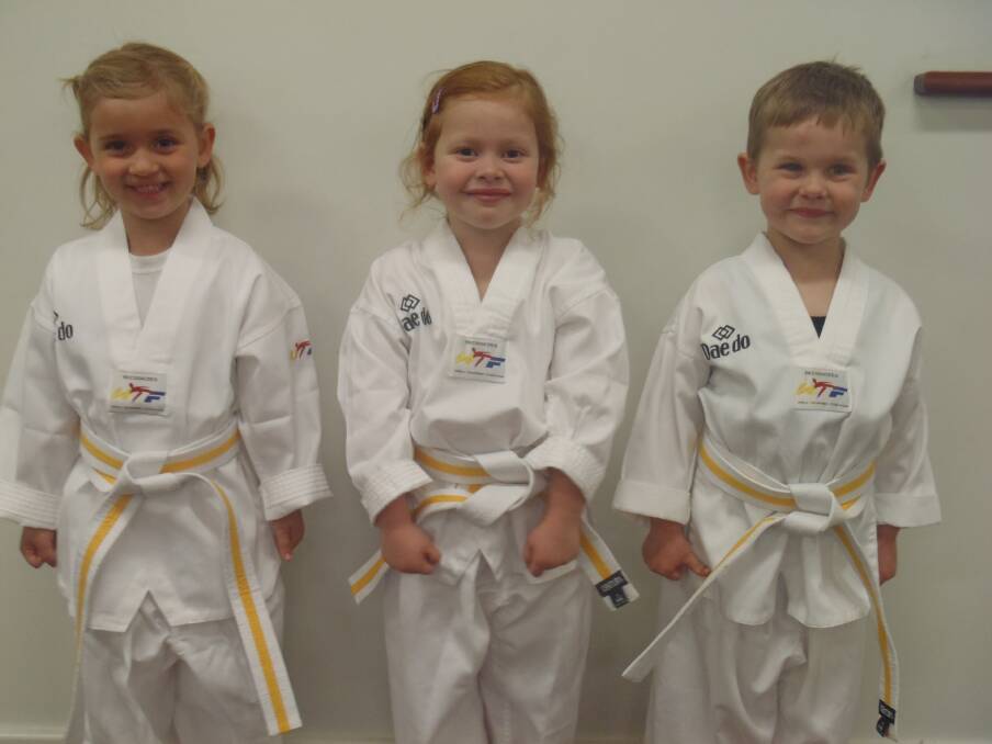 Abby Turner, Summer Marrapodi and Eric Buhlmann proudly showing off the Yellow Dragonfly Belt they earned. 