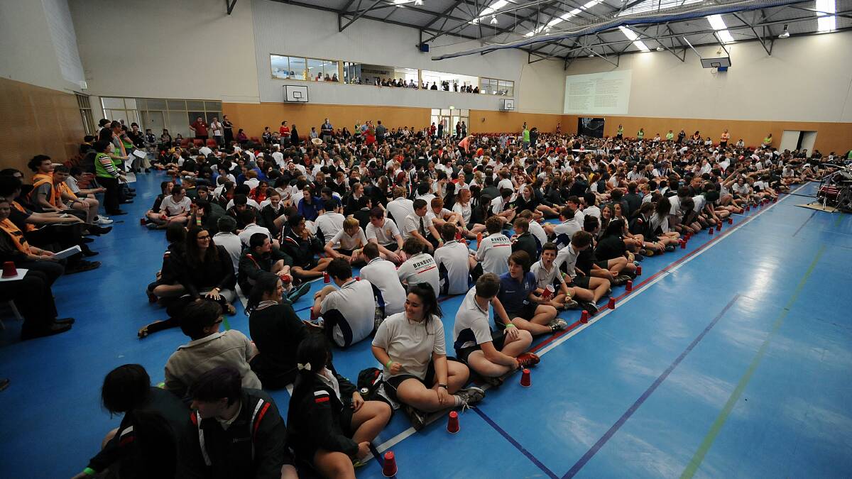 The students perform the Cup Song to claim a Guinness World Record. 