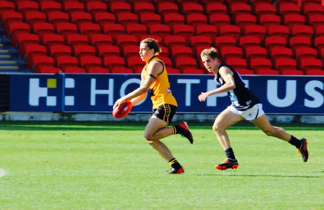 Bunbury player Aidan Clarke running for goal in the state 16s AFL championships in the Gold Coast. 