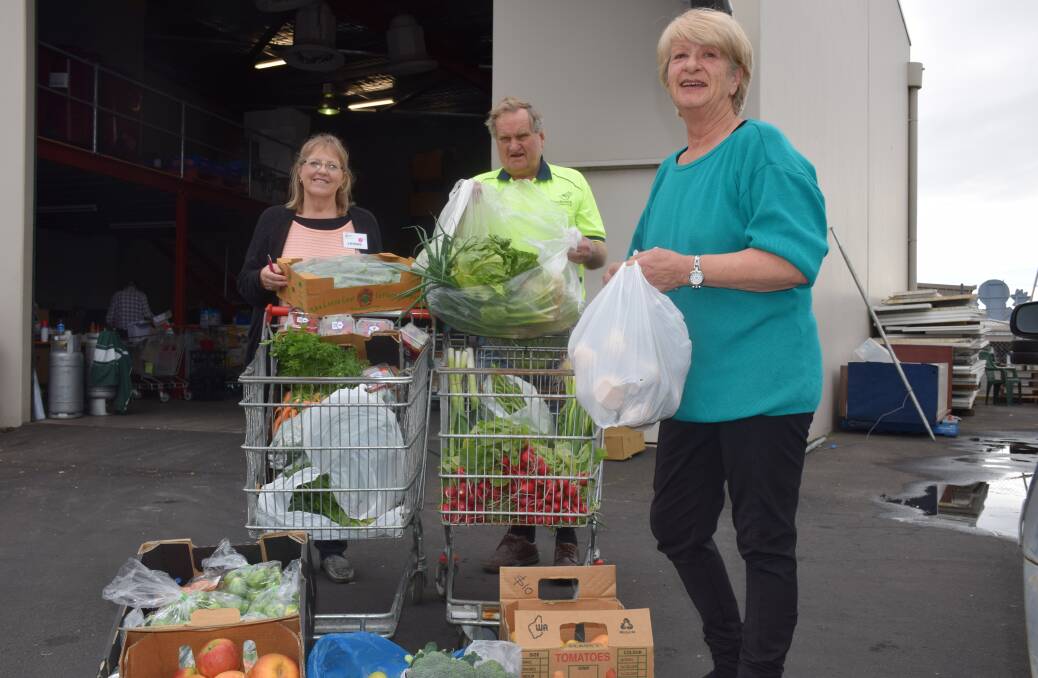 Janette Fry (right) with 150 kilograms of fresh fruit and vegetables ready to hand over to Bunbury Foodbank staff Leonie Jane and Ray Jordan.