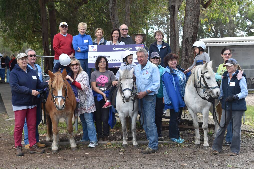 TAB Corp presented Riding for the Disabled with a cheque worth $5,000.
