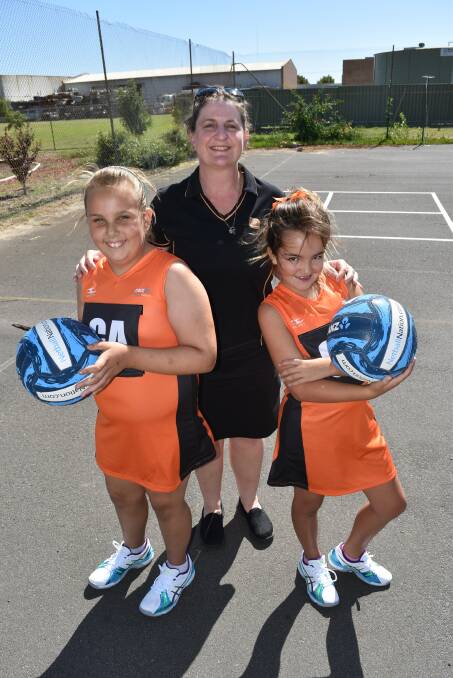 Student Tandia Halzapfel, Cooinda Primary School netball coordinator Karen Field and student Jordan Brady.