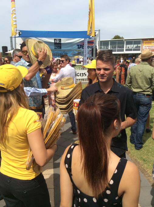 The XXXX Gold team giving away freebies to happy punters.