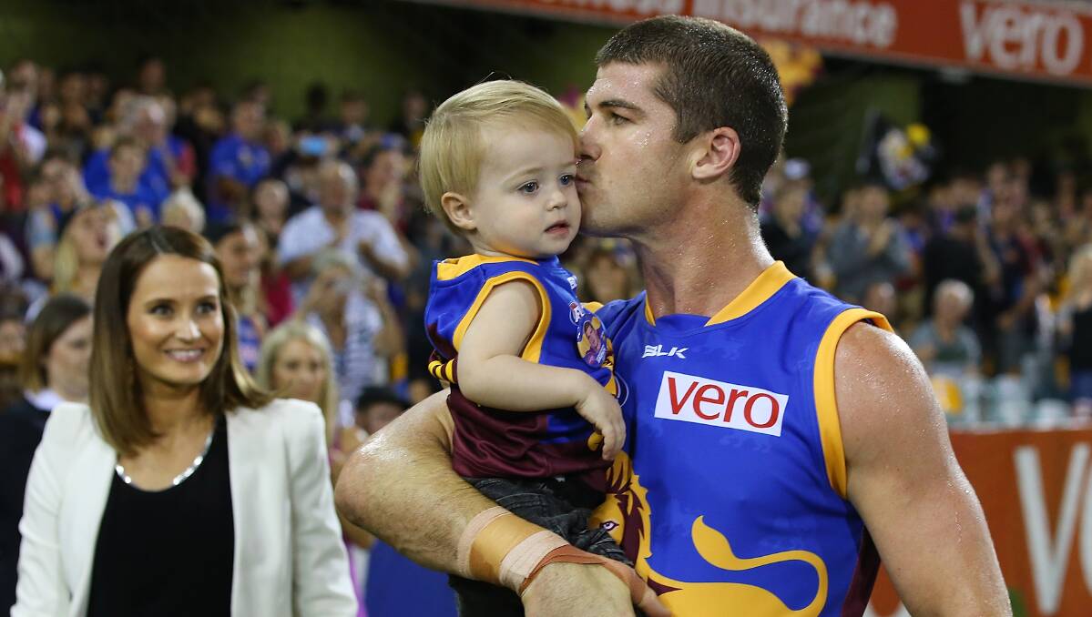 Jonathan Brown kisses his son Jack while his wife Kylie looks on. Brown is playing 250th game during the round five AFL match between the Brisbane Lions and the Richmond Tigers at The Gabba on April 17, 2014 in Brisbane, Australia. Photo: Chris Hyde/Getty Images.