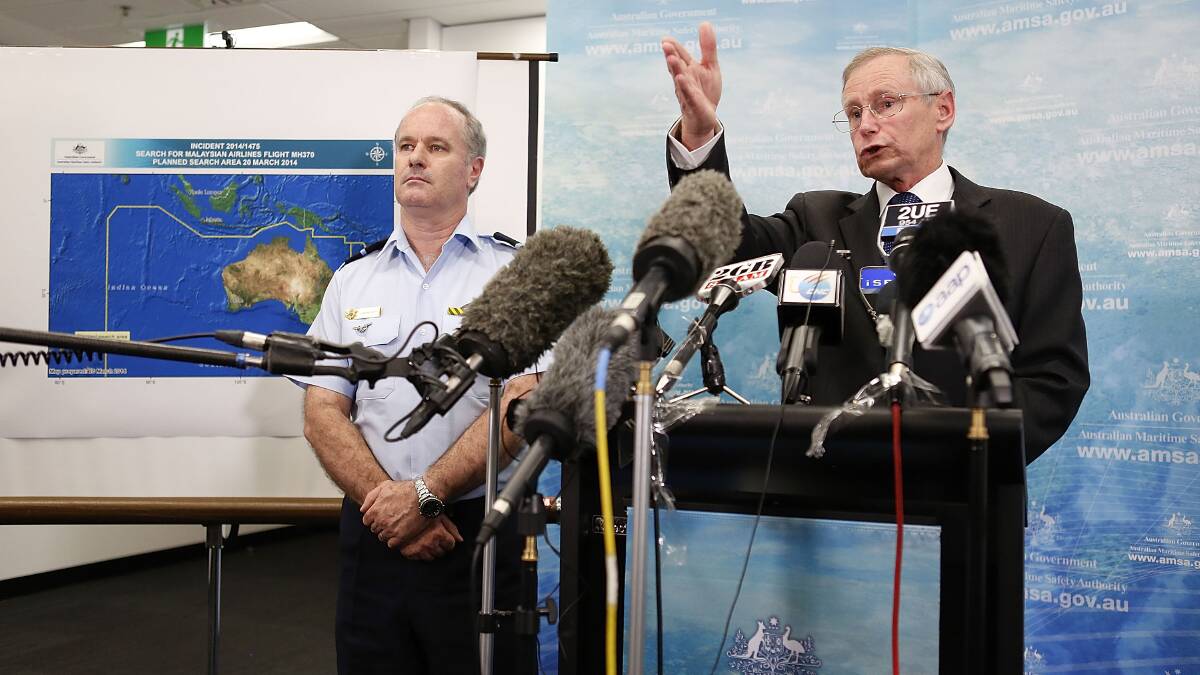 Australian Maritime Safety Authority Emergency Response Division general manager John Young, right, speaks to the media alongside Director General Military Strategic Commitments John McGarry about satellite imagery of objects possibly related to the search for Malaysian Airlines flight MH370 on March 20 in Canberra. Photo: Getty Images.