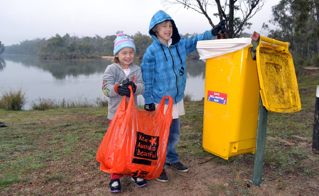 Keeping Collie clean: Ericah King and Dylan King do their part.