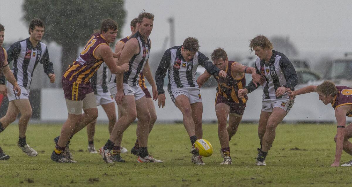 Busselton and Harvey-Brunswick-Leschenault fought out a tough game in the wet on Saturday. Pictured is Jordan Eastwell getting a kick away.
