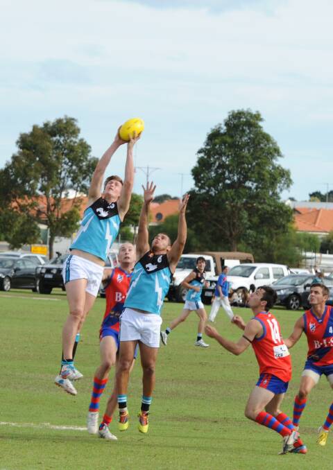 Collie's Christian Pocklington takes a strong mark with support from teammate Matt Michael.
