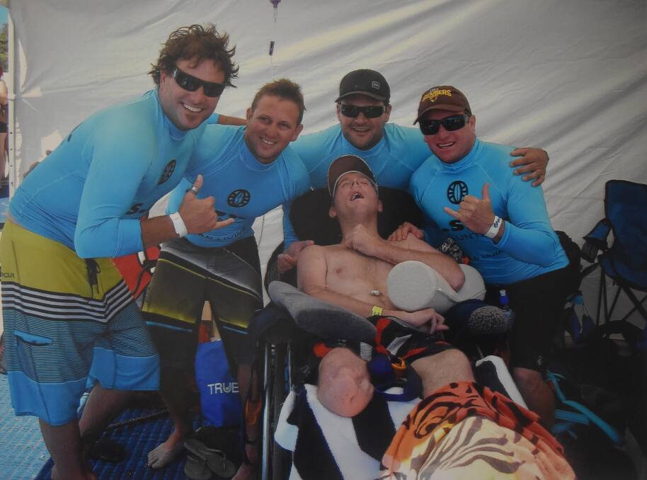 Glen Allen, Wes Frazer, Clinton Black and Paul Perry help their friend James Murray enjoy a day surfing.  