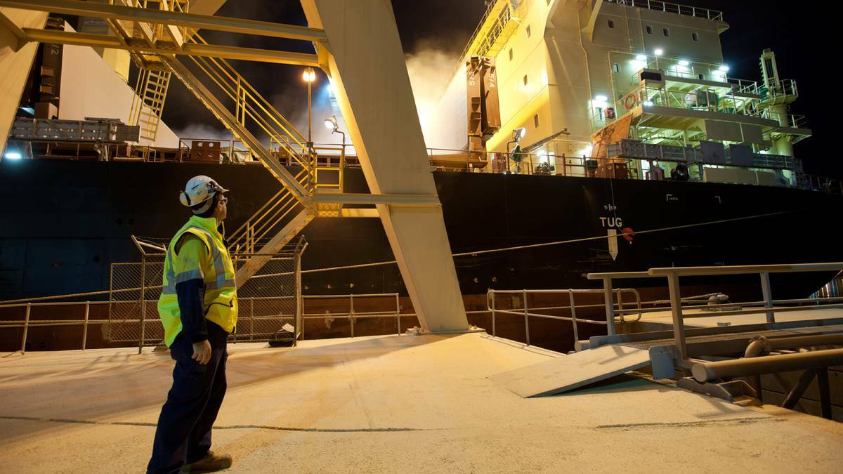 A Bunge Australia employee witnesses the very first shipment of WA grain loaded at Bunge's Bunbury port facility in July this year. 