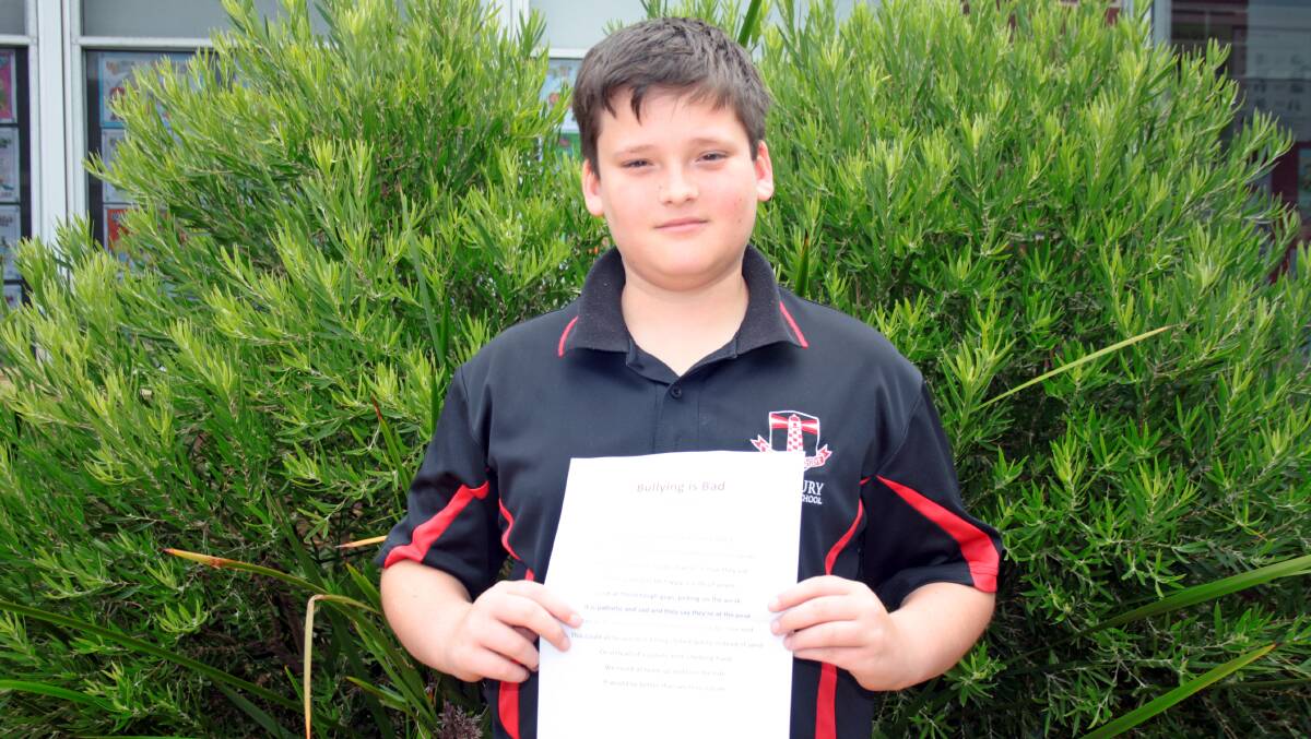 Bunbury Primary School student Joel Brown with his poem Bullying is Bad.