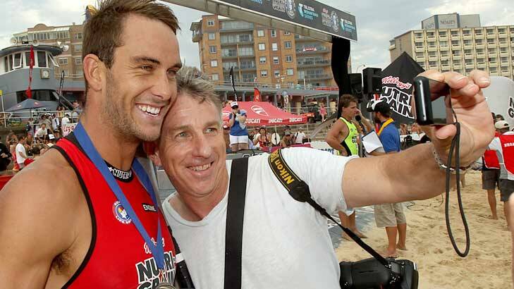 Ironman Matt Poole with  Eddie 'Groover" Cross who crashed a TV interview so he could get a 'selfie'. Photo: Jonathan Carroll