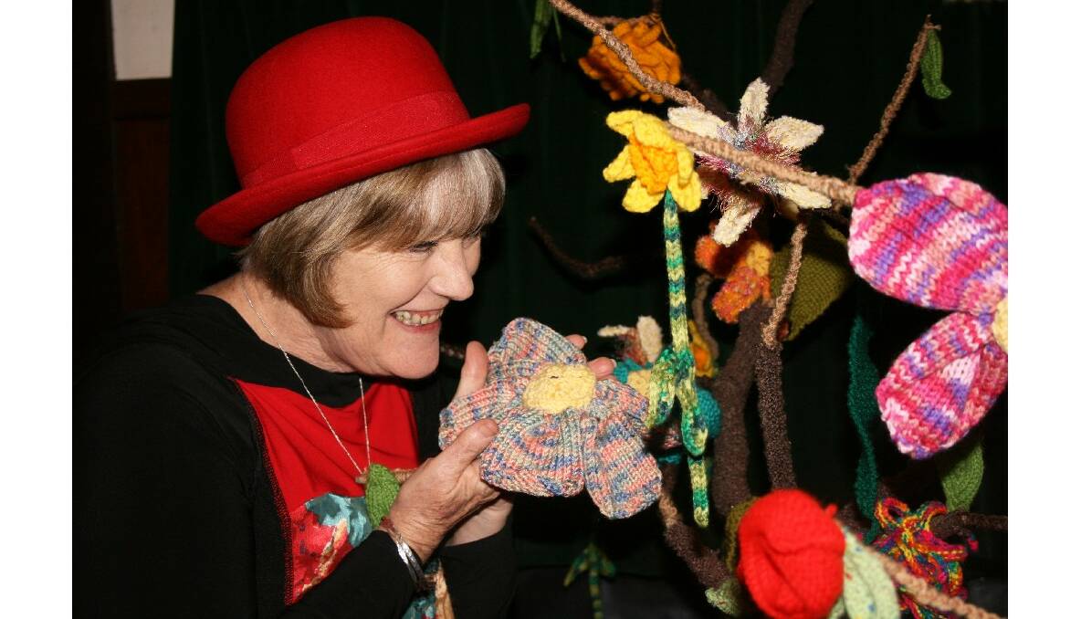 Janet Gray smells a knitted flower at the Nannup Flower Festival. Photo: Rachel Tyrrell