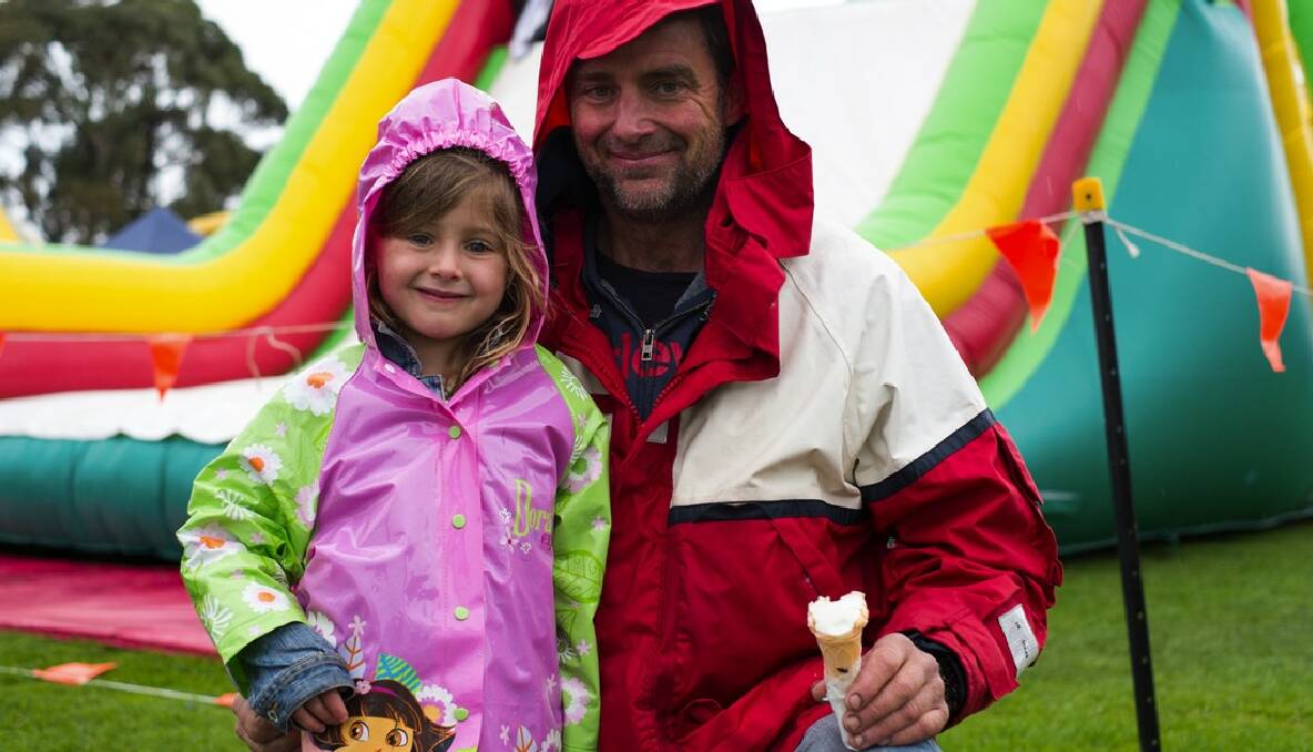 Father and daughter Billie and Andy McDonald enjoy an icecream in the rain at the Margaret River ag show. Photo by Sandy Powell.