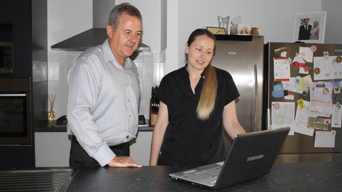 Telstra South West area general manager Boyd Brown and Treendale resident Sarah Garbelini marvel at the speed of the national broadband network. 