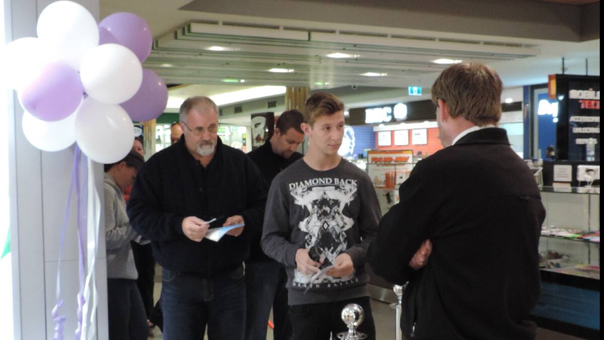 Customers lining up to be the first in Bunbury to have the new Iphone launched on Friday morning. 