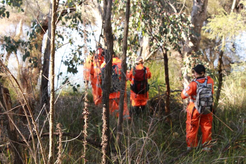 Ses volunteers search along the Collie River for missing teenager Joshua Mcleod.