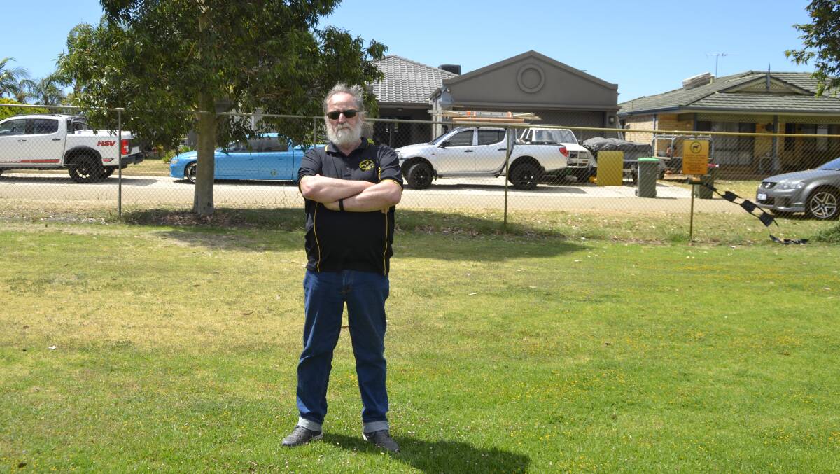 Preferred option: Mr Cook standing at the club's preferred location for the sea container, which was refused by council due to a letter of objection from a resident on Cowin Gardens. Picture: Pip Waller 